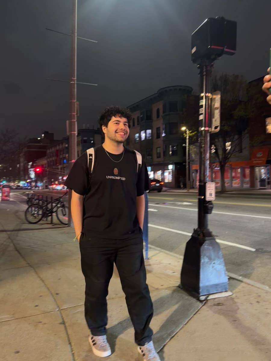 A musician standing on a city street at night